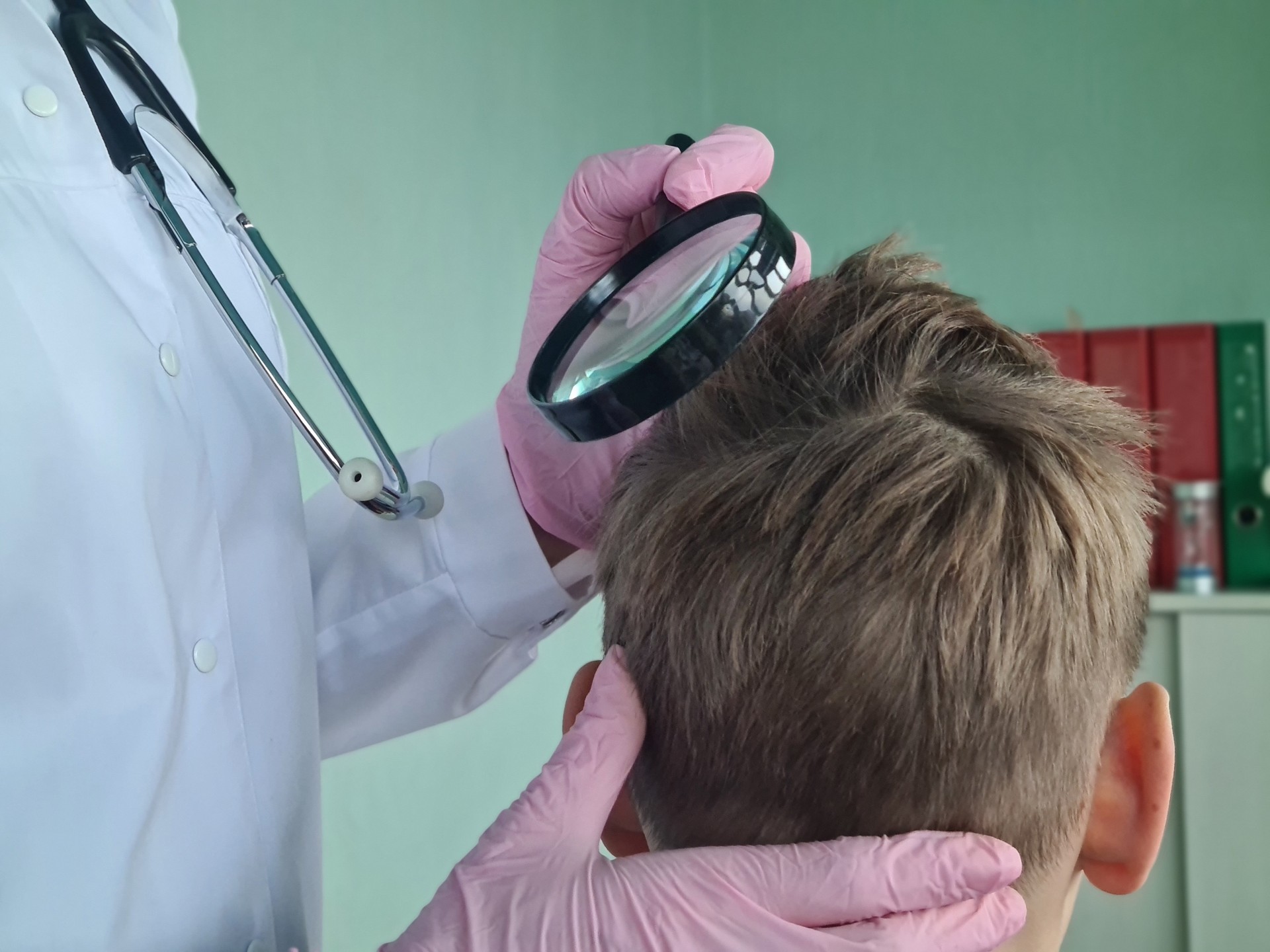 Trichologist examines condition of teenage boyhair